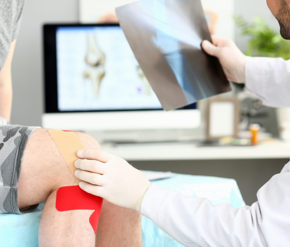 Doctor with patient holding xray shot prescribing treatment closeup